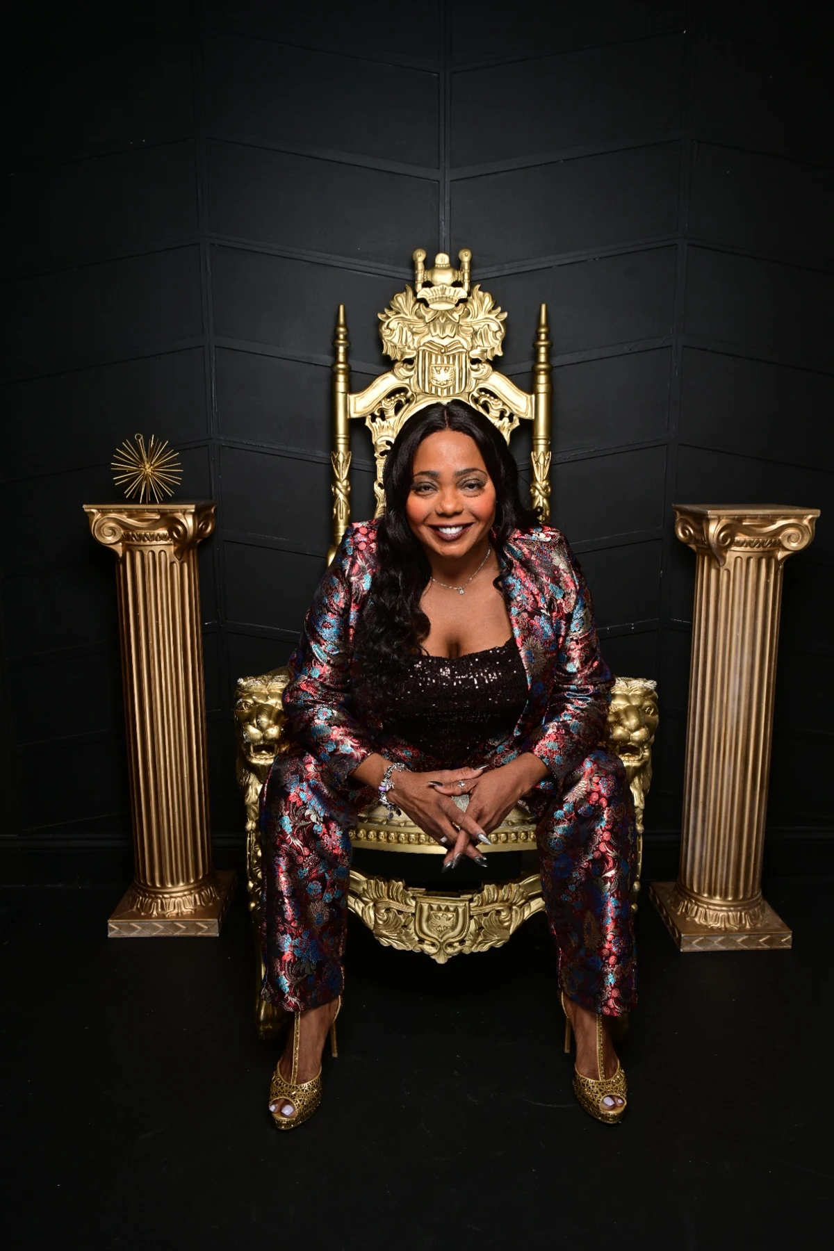 Cocoa Brown seated on her gold throne